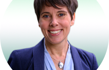A professional headshot of Sonia Furstenau in front of a gradient green background.
