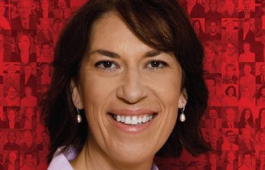 A professional headshot on a red background of Pontiac Liberal candidate Sophie Chatel.