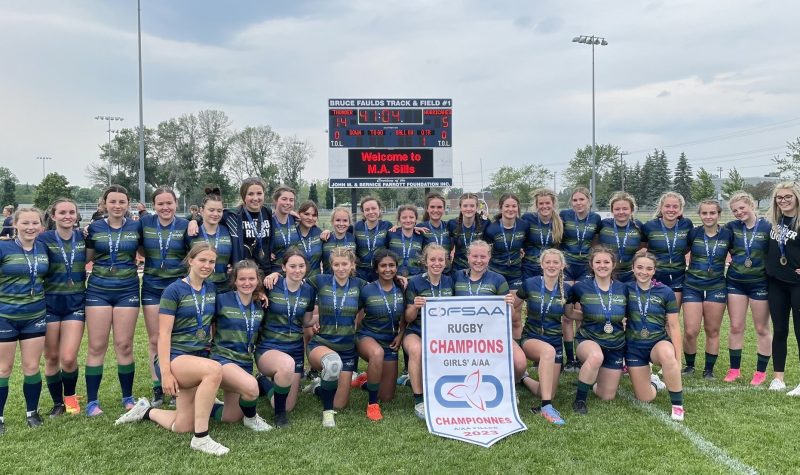 Rugby team photo with championship banner