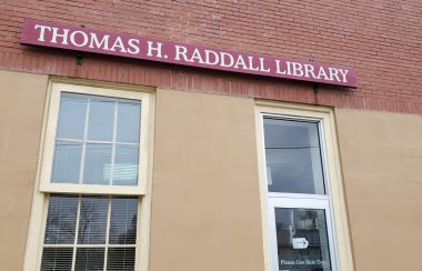 Sign over windows for the Thomas H Raddall in Liverpool