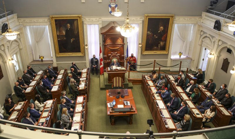 A view looking down from above on all members of the legislature seated at their desks