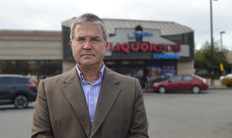 Dr. Tim Naimi standing in the parking lot of a B.C. Liquor Store.