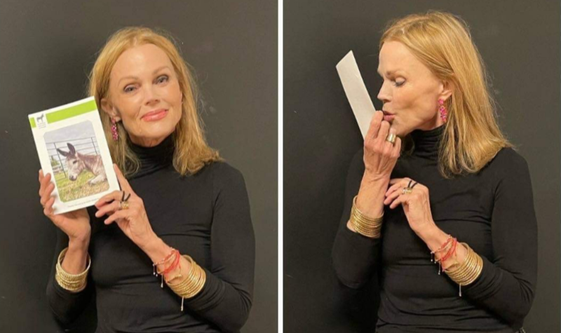 Belinda Carlisle kisses and holds a picture of 'Duke'