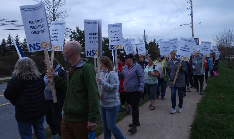 Workers walk a picket line