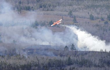 Water bomber dropping its load on part of a wildfire near South Horseshoe Lake, Yarmouth County