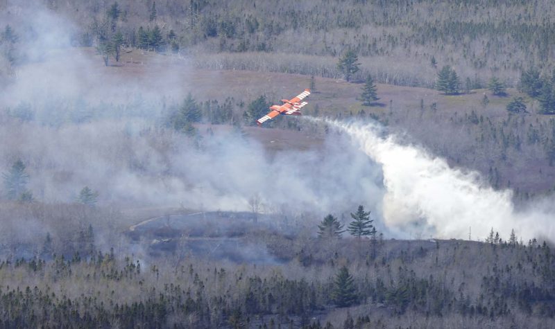 Water bomber dropping its load on part of a wildfire near South Horseshoe Lake, Yarmouth County