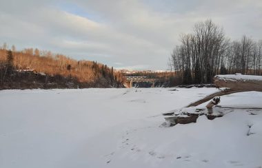 A snow covered Peace River near the Site C dam on a sunny day