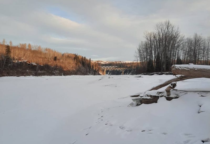 A snow covered Peace River near the Site C dam on a sunny day