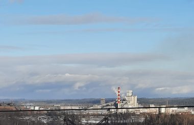 An image of a pulp mill in the distance.