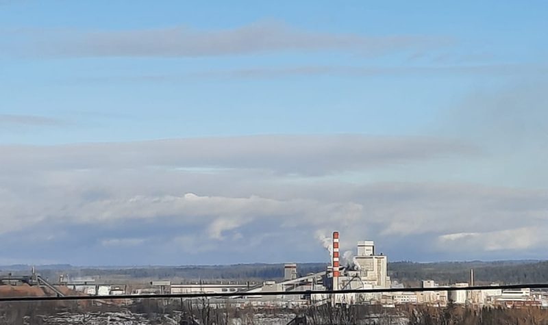 An image of a pulp mill in the distance.