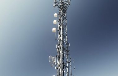 Une antenne de télécommunication entourée d'un ciel bleu.