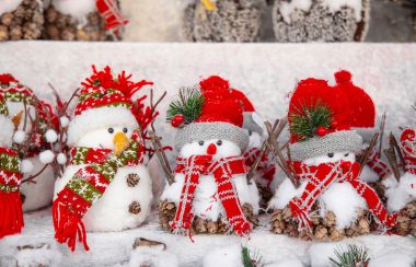 A row of little dressed-up snowmen toys.