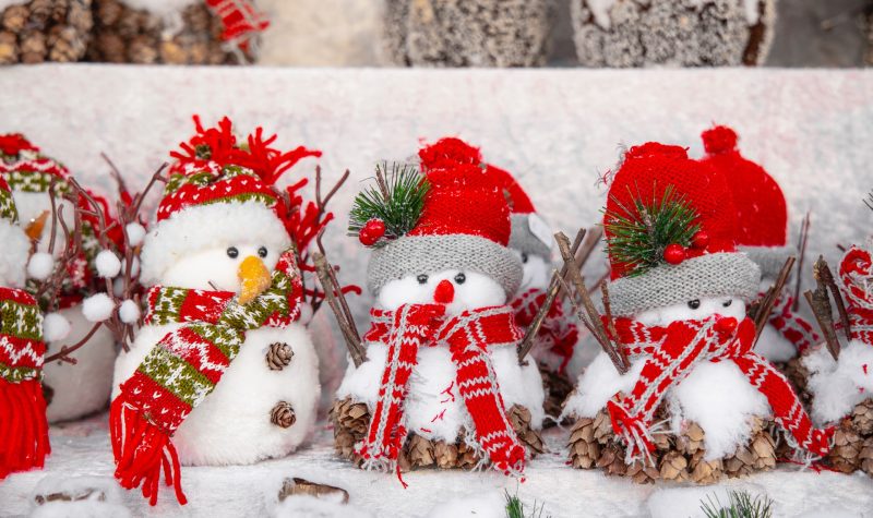 A row of little dressed-up snowmen toys.