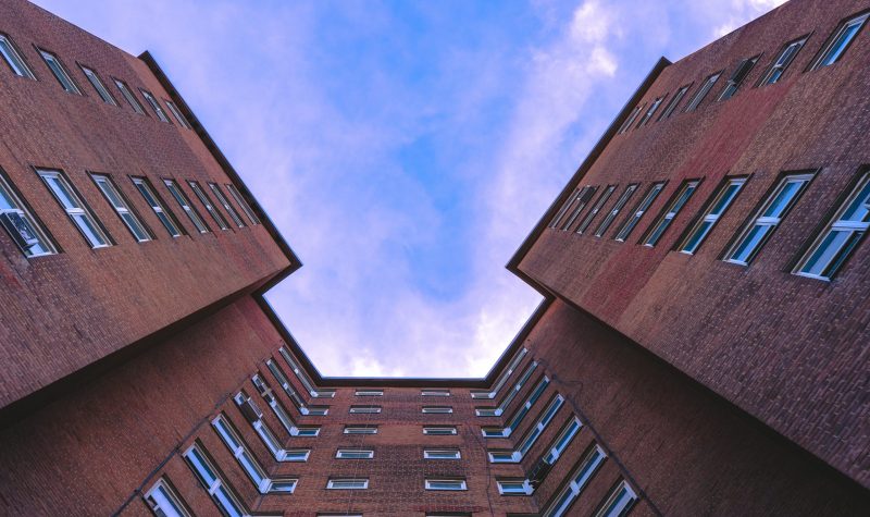 Photo of apartment building facade facing up to the sky