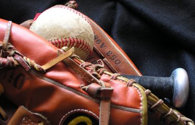 A closeup of a baseball in a baseball glove.
