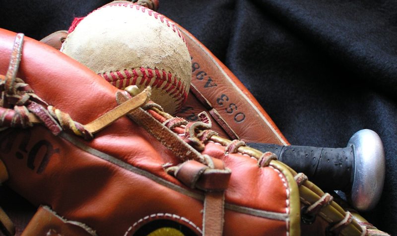 A closeup of a baseball in a baseball glove.