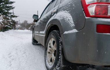 Ciel gris et présence d'une voiture grise sur un mince tapis neigeux