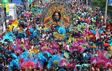 A crowd of people in various colourful costumes on a street