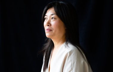 A portrait of Cindy Mochizuki with a black background