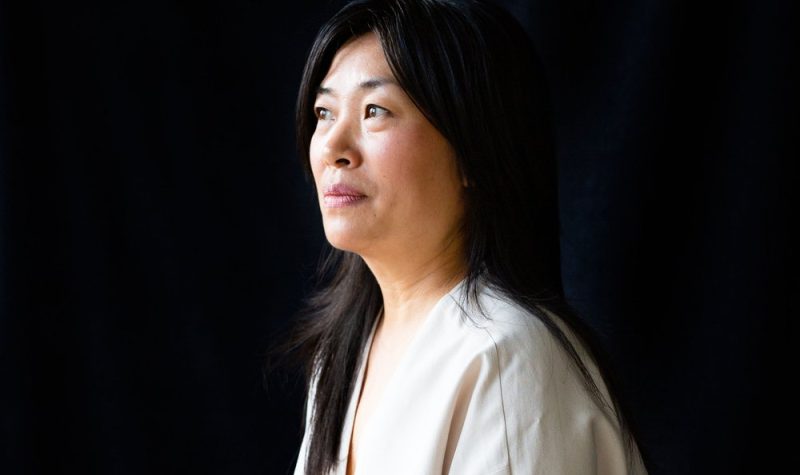 A portrait of Cindy Mochizuki with a black background