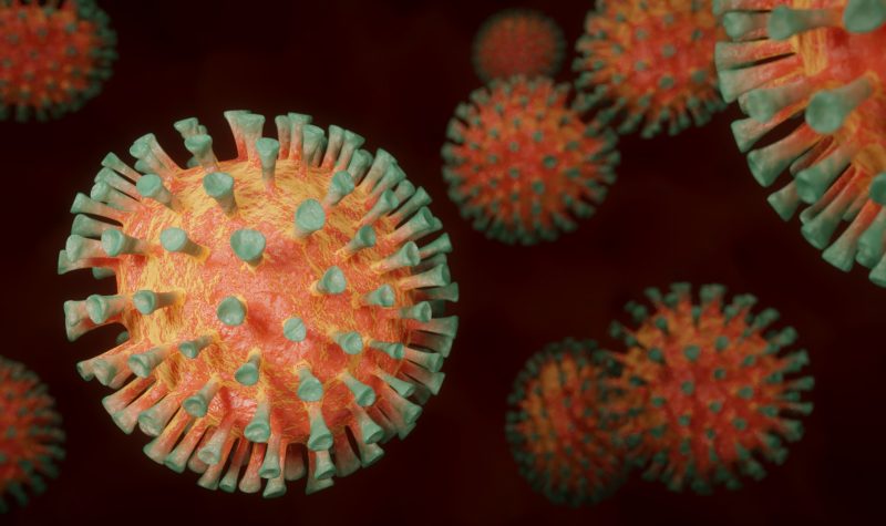 Image du Coronavirus rond orange avec des mini trompettes vertes tout autour