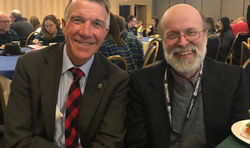 A photo of David Gillespie with Vermont Governor Phil Scott, with Gillespie on the right in a jacket and glasses, and Scott on the left in a suit and red tie.