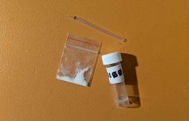 Drug paraphernalia, a small sample of white powder and a sampling container.