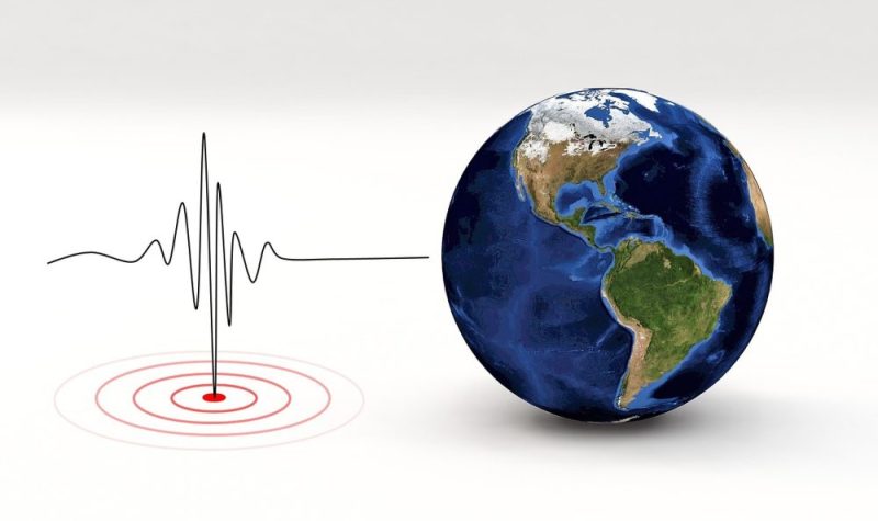 Graphique représentant une onde sismique au côté de la planète Terre.