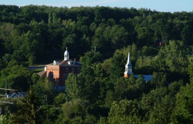 Pictured is a long shot of the village of Frelighsburg. The top of the local elementary school and church can be seen in the distance.