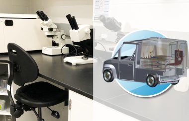 Un laboratoire de science avec des microscopes et un camion avec un laboratoire mobile.