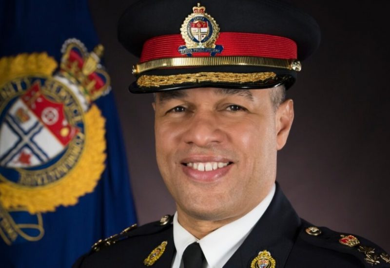 A headshot of Ottawa police chief Peter Sloly in uniform in front of a dark background and OPS symbol