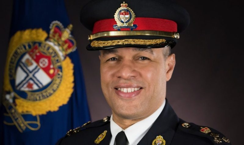 A headshot of Ottawa police chief Peter Sloly in uniform in front of a dark background and OPS symbol