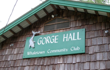 A green sign for the Gorge Hall.