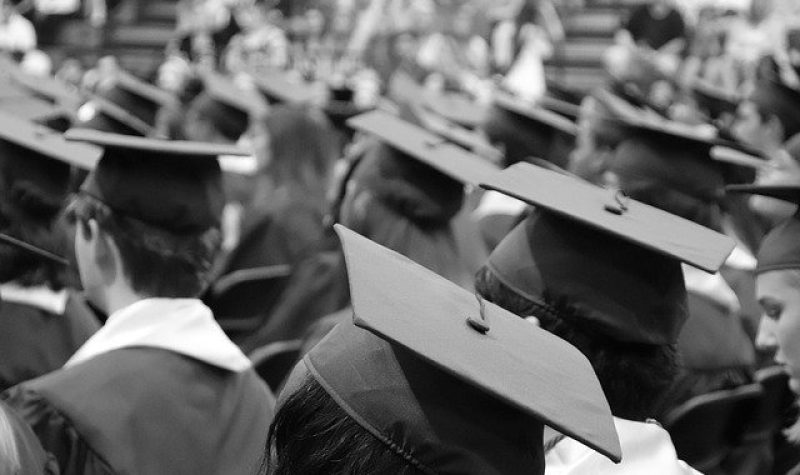 Photo en noir et blanc d'élèves portant le mortier à leur graduation.