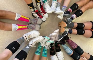 The hazelton spartan volleyball team poses for a photo of just their socks and legs