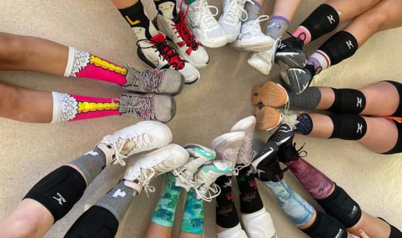 The hazelton spartan volleyball team poses for a photo of just their socks and legs