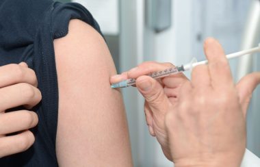 patient receiving vaccination in upper arm