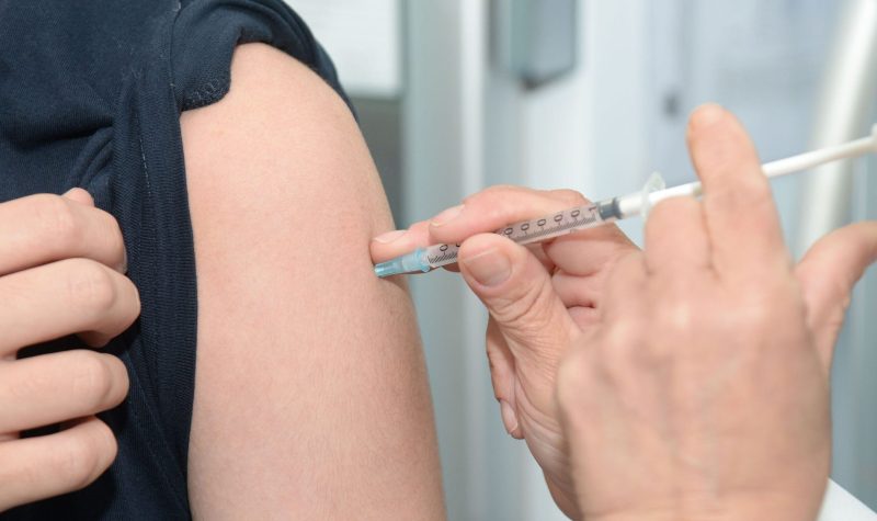 patient receiving vaccination in upper arm