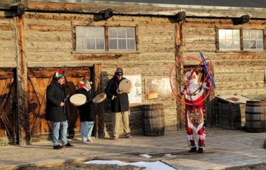 A performance of Blackfoot Santa, otherwise known as Napi. The performance featuring songs and dance. Weather is sunny.