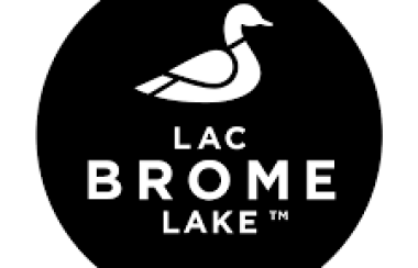 Black circle with a white duck picture and the words Lac Brome Lake