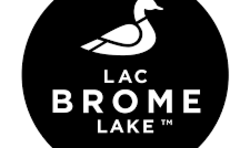 Black circle with a white duck picture and the words Lac Brome Lake
