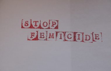 Les mots « Stop Feminide» étampés en rouge sur une feuille blanche.