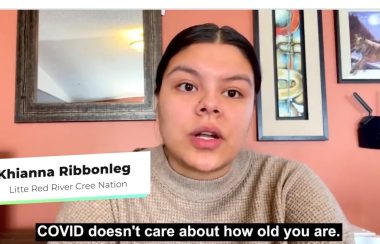 Treaty 8 youth from Southern Alberta appears in a COVID-19 Awareness video, indigenous female with black hair tied in ponytail wearing a beige sweater