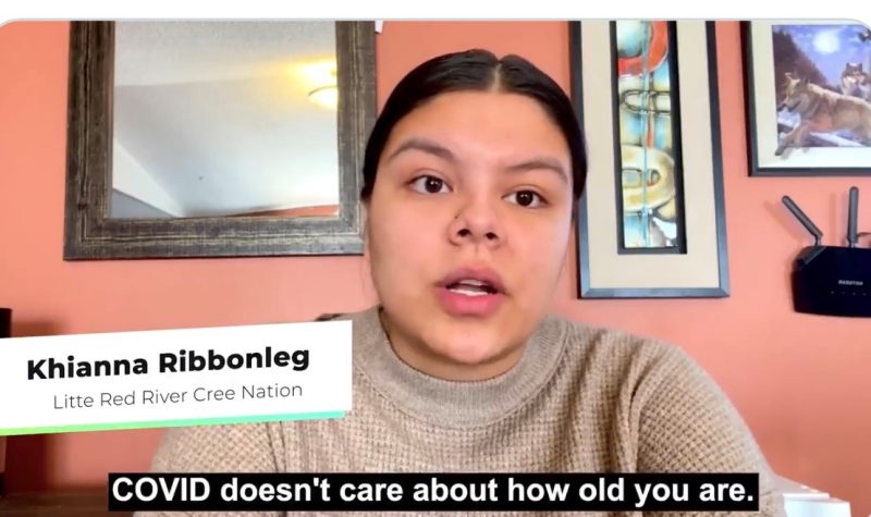 Treaty 8 youth from Southern Alberta appears in a COVID-19 Awareness video, indigenous female with black hair tied in ponytail wearing a beige sweater