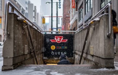 Photo of the underground entrance leading to Queen subway station in Toronto.