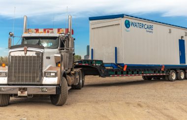 Transport truck with a seacan with a portable pump system for wastewater treatment system