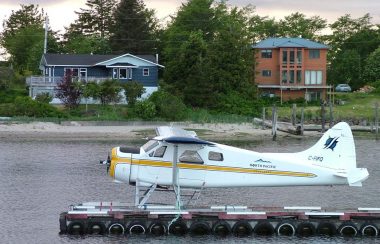 A floatplane waits on a dock on the water outside of the town of Masset on Haida Gwaii.
