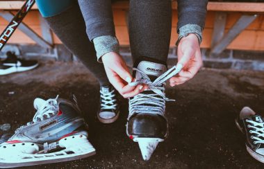 Photo of hockey player lacing up their skates