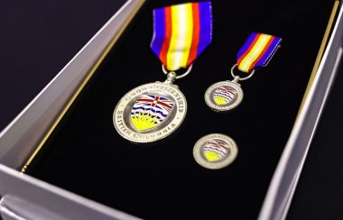 a case with medals with the flag of British Columbia