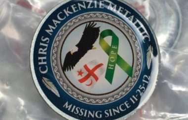 A ceramic pin with text: Chris Mackenzie Metallic, Missing since Nov 25, 2012 and images of a green ribbon, the Mikmaq flag and an eagle.